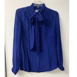Blue and black patterned silk tie-neck blouse.
